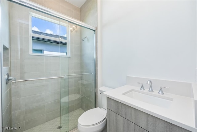 bathroom with vanity, toilet, and walk in shower