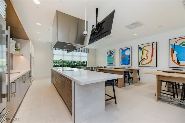 kitchen featuring a large island, a kitchen bar, and stainless steel double oven