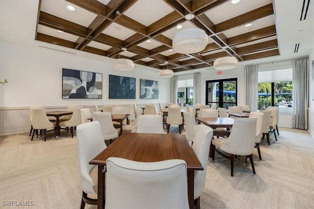 dining area featuring beamed ceiling, coffered ceiling, and light colored carpet