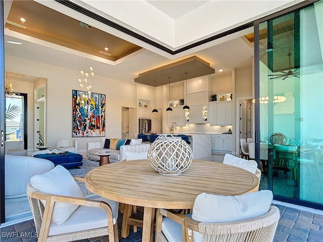 dining space with a raised ceiling