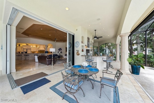 view of patio / terrace with ceiling fan and glass enclosure