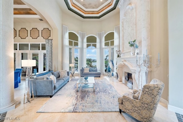 living room featuring ornamental molding, a towering ceiling, coffered ceiling, a premium fireplace, and beamed ceiling