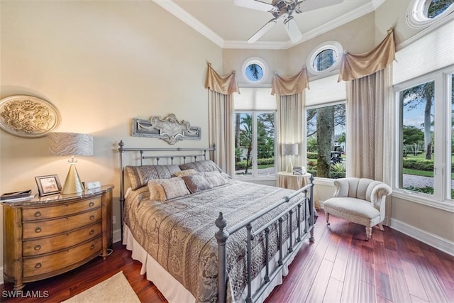 bedroom featuring dark wood-type flooring, ornamental molding, and ceiling fan