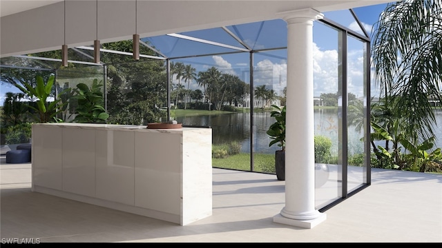 doorway to outside with a water view and floor to ceiling windows