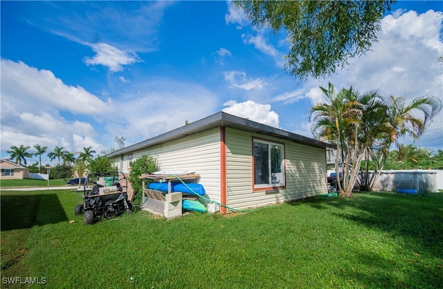 view of side of home featuring a yard