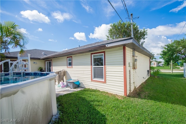 back of property featuring a yard