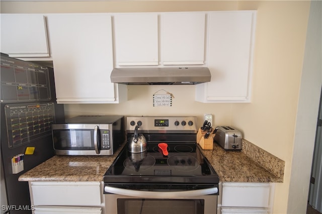 kitchen featuring dark stone counters, white cabinetry, and stainless steel appliances