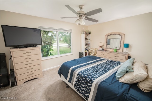 bedroom with ceiling fan and light colored carpet