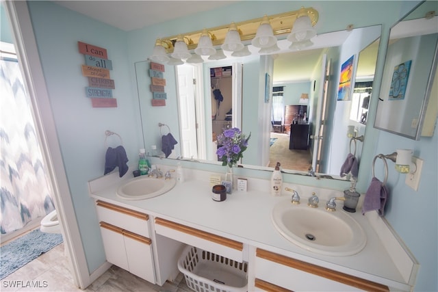 bathroom featuring tile patterned flooring, vanity, and toilet