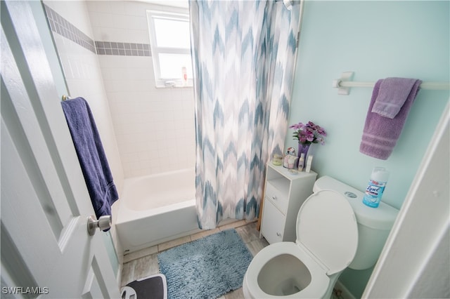 bathroom with shower / bath combo with shower curtain and toilet