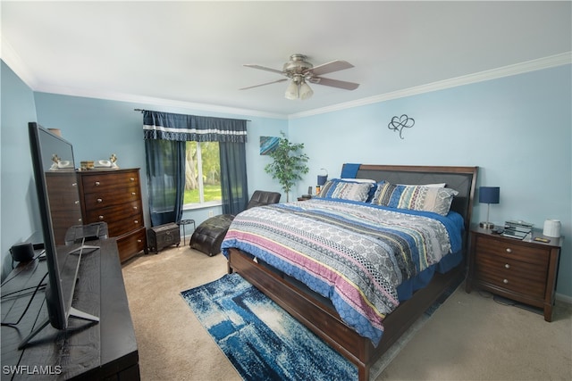 carpeted bedroom with ornamental molding and ceiling fan