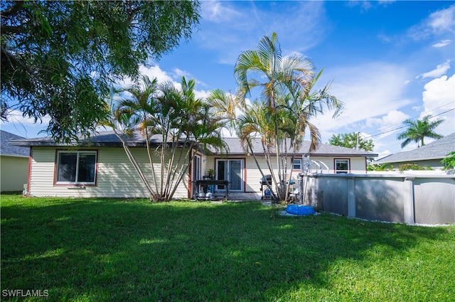 back of property featuring a lawn