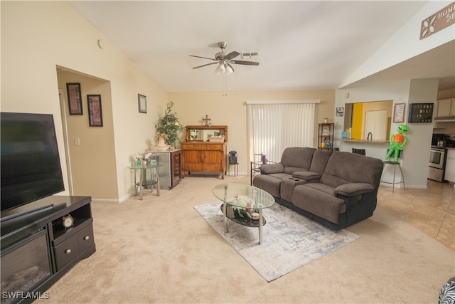 carpeted living room with ceiling fan and lofted ceiling