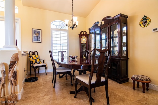 dining area featuring ornate columns and a chandelier