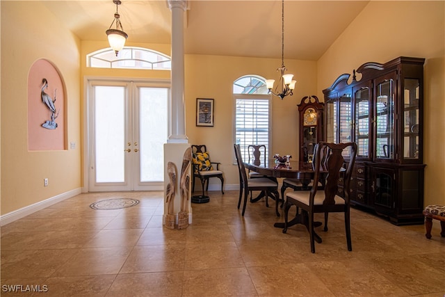 dining area featuring a high ceiling, french doors, tile patterned floors, ornate columns, and a chandelier