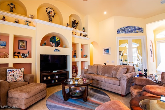 living room featuring built in features and french doors