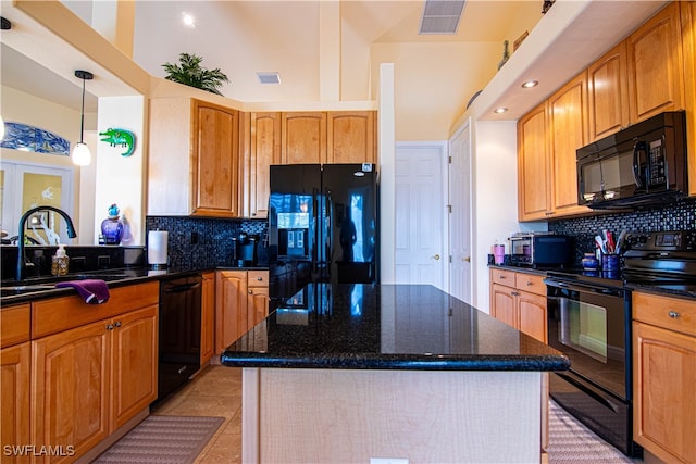 kitchen with a center island, sink, hanging light fixtures, a towering ceiling, and black appliances