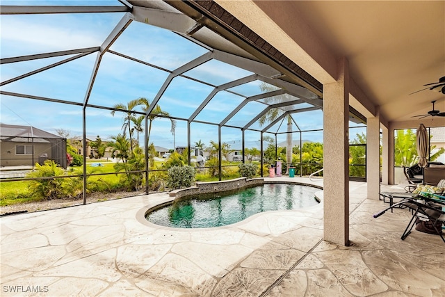 view of pool with glass enclosure, ceiling fan, and a patio area