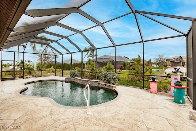 view of swimming pool featuring a lanai and a patio