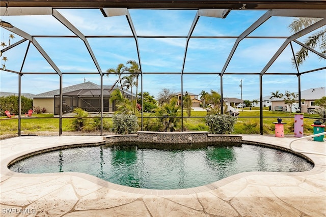 view of pool with a patio area and a lanai