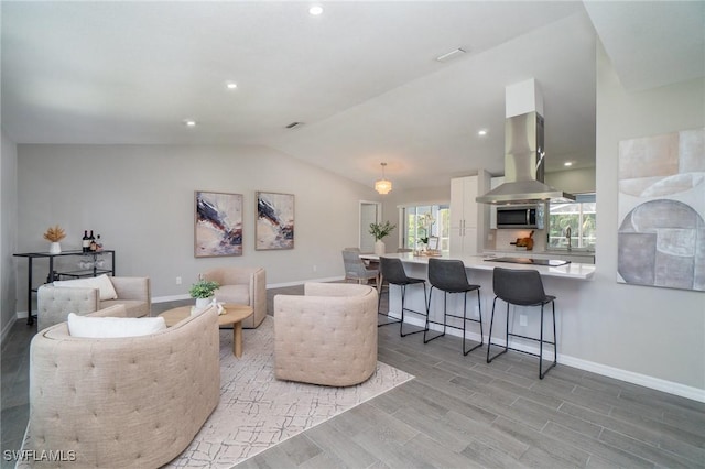 living room featuring sink and vaulted ceiling