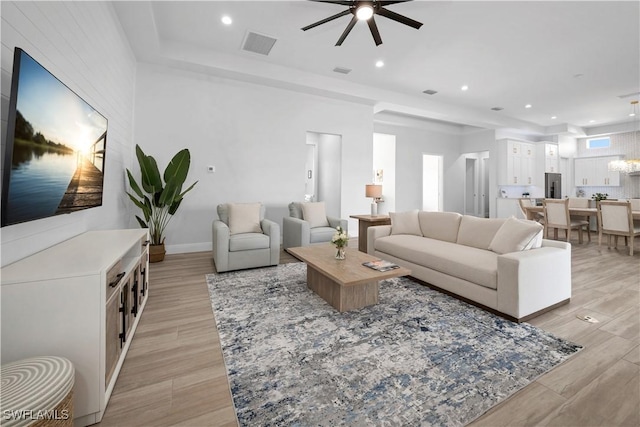 living room featuring light hardwood / wood-style floors and ceiling fan