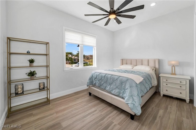 bedroom with ceiling fan and light wood-type flooring