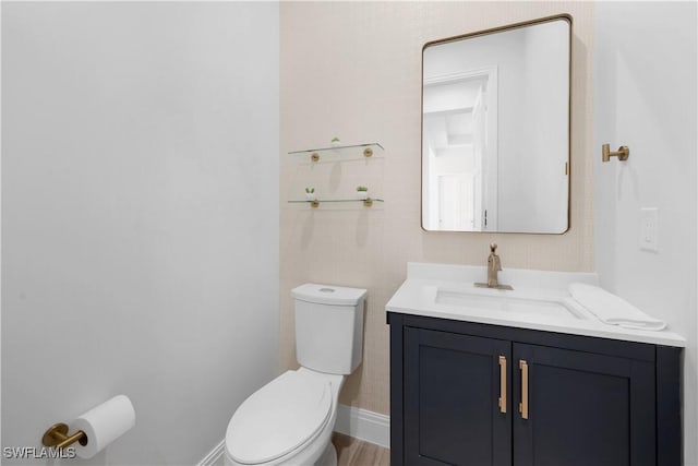 bathroom featuring hardwood / wood-style floors, vanity, and toilet