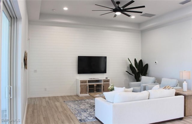 living room featuring ceiling fan and light wood-type flooring