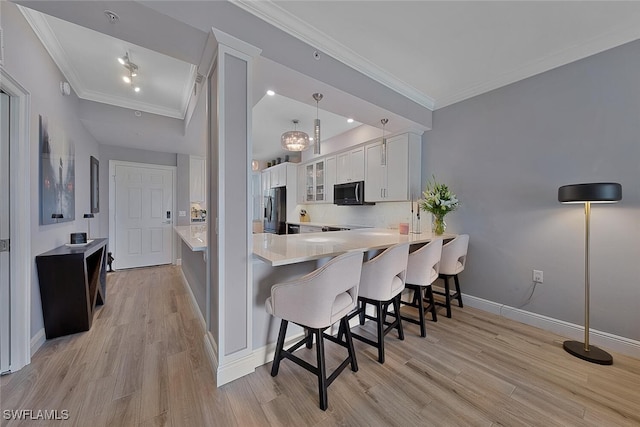 kitchen with a kitchen bar, stainless steel refrigerator with ice dispenser, kitchen peninsula, light hardwood / wood-style flooring, and white cabinets