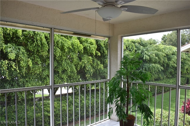 unfurnished sunroom featuring ceiling fan