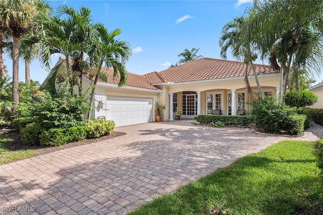 mediterranean / spanish-style home with a garage