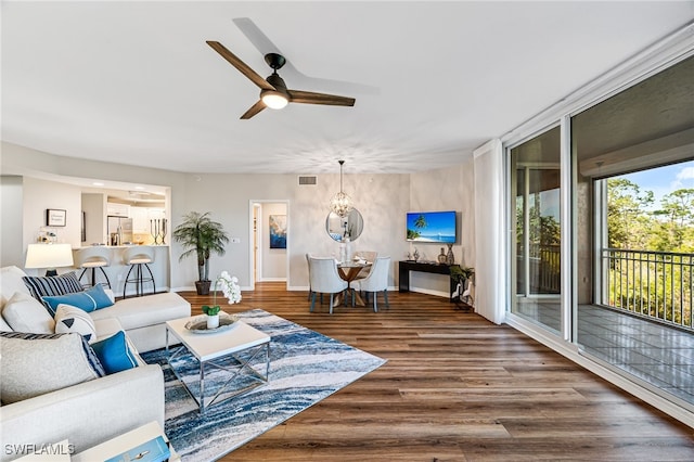 living room featuring hardwood / wood-style floors and ceiling fan with notable chandelier