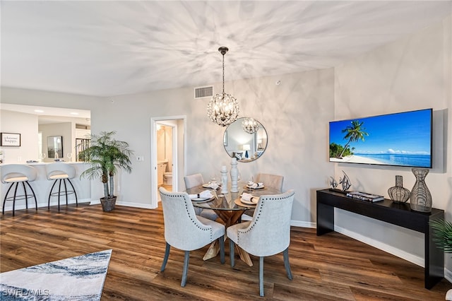 dining area featuring dark hardwood / wood-style floors and a notable chandelier