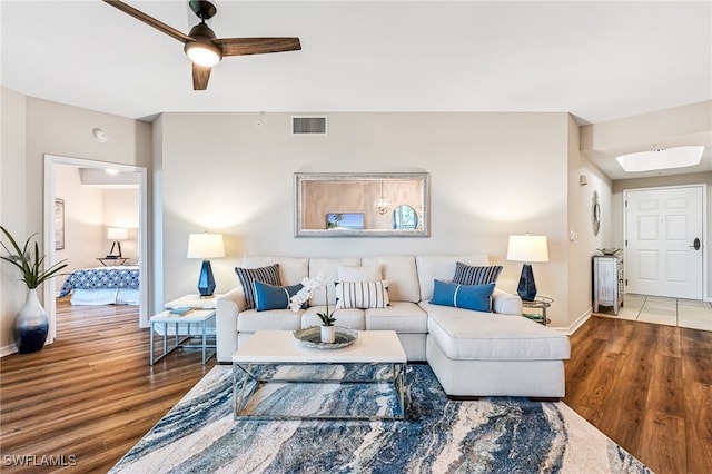 living room with hardwood / wood-style flooring and ceiling fan