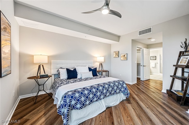 bedroom with ensuite bathroom, ceiling fan, and dark wood-type flooring