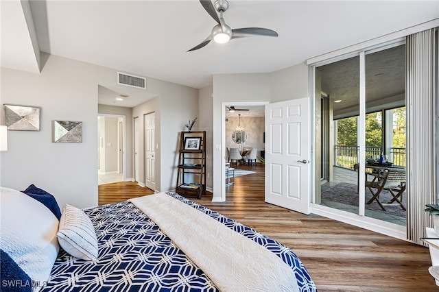 bedroom with hardwood / wood-style floors, ceiling fan, and access to exterior