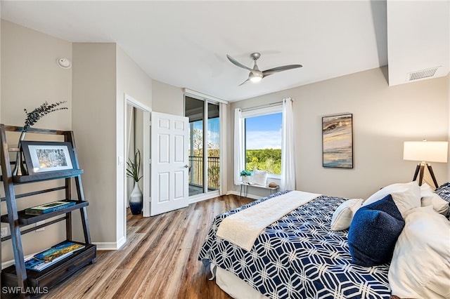 bedroom featuring access to exterior, wood-type flooring, and ceiling fan