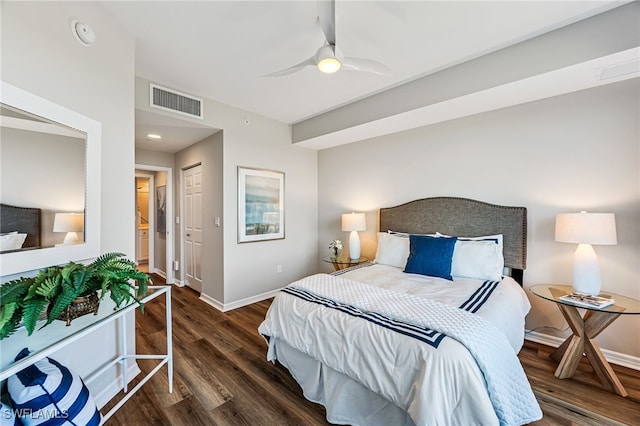 bedroom featuring ceiling fan, dark wood-type flooring, and a closet