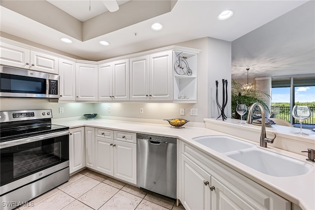 kitchen featuring white cabinetry, sink, light tile patterned flooring, and appliances with stainless steel finishes