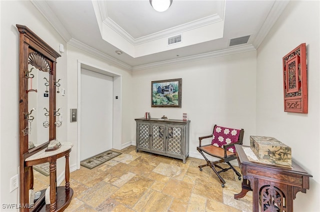 entryway featuring ornamental molding and a raised ceiling