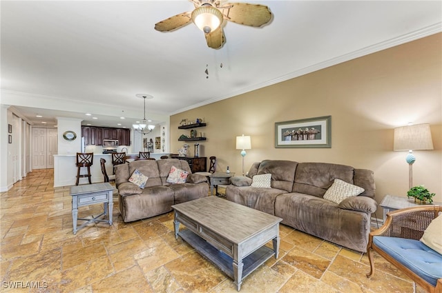 living room with ceiling fan with notable chandelier and crown molding