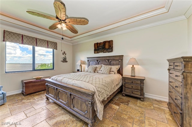 bedroom featuring ceiling fan, a raised ceiling, and ornamental molding