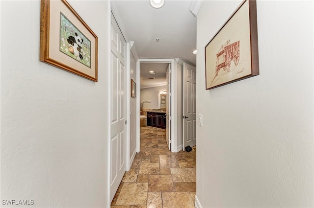 hallway featuring ornamental molding