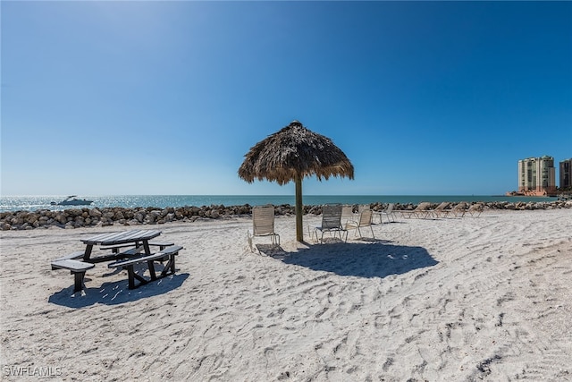 surrounding community with a view of the beach and a water view