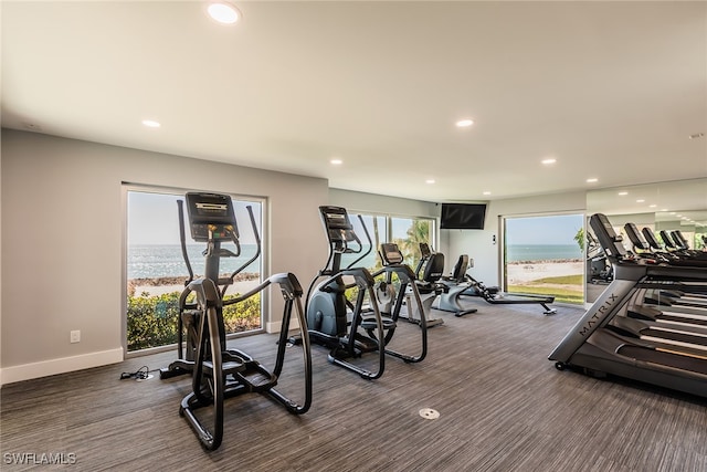 exercise room with a water view