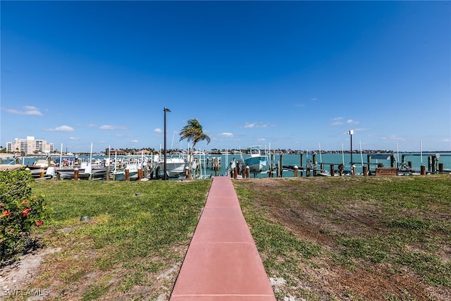 dock area featuring a lawn and a water view