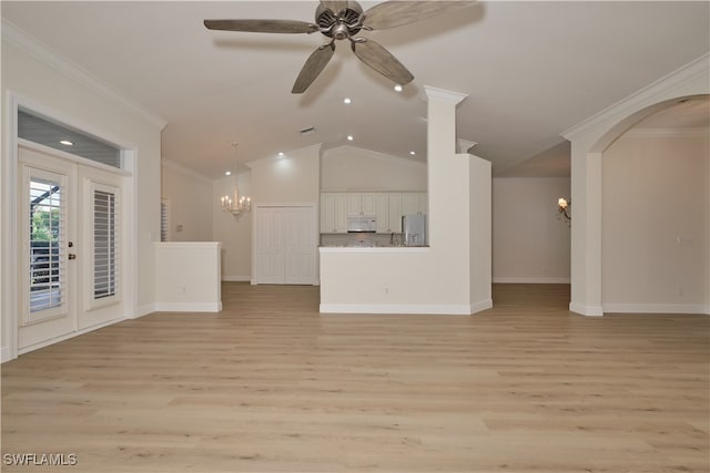 unfurnished living room featuring lofted ceiling, ornamental molding, french doors, and light hardwood / wood-style floors