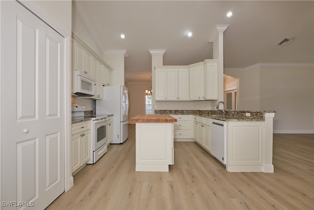 kitchen featuring white appliances, white cabinetry, light wood-type flooring, ornamental molding, and butcher block countertops