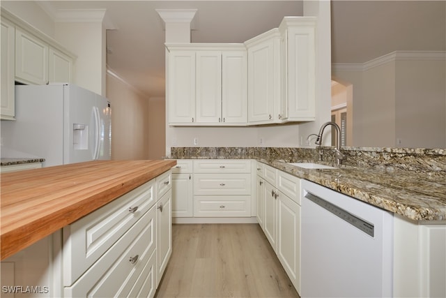 kitchen with white cabinets, sink, and white appliances